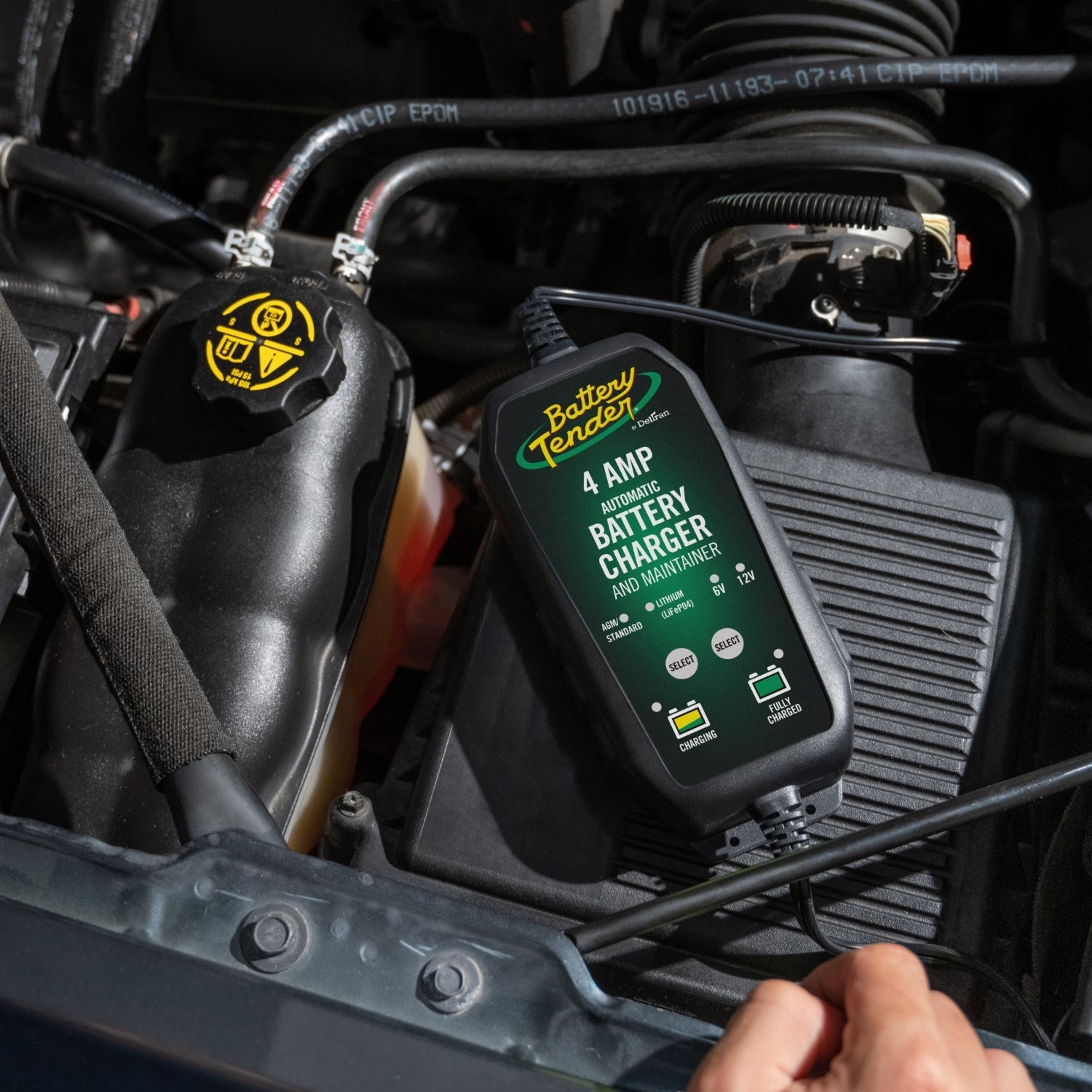 A Battery Tender® battery charger is hooked up to a car battery.