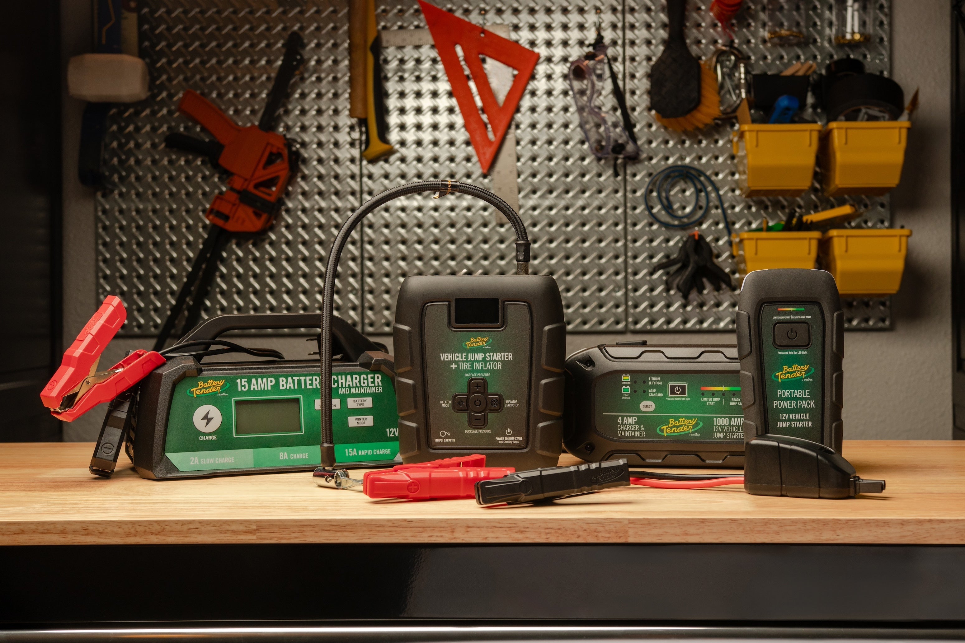 A variety of Battery Tender® products on display on a workbench.